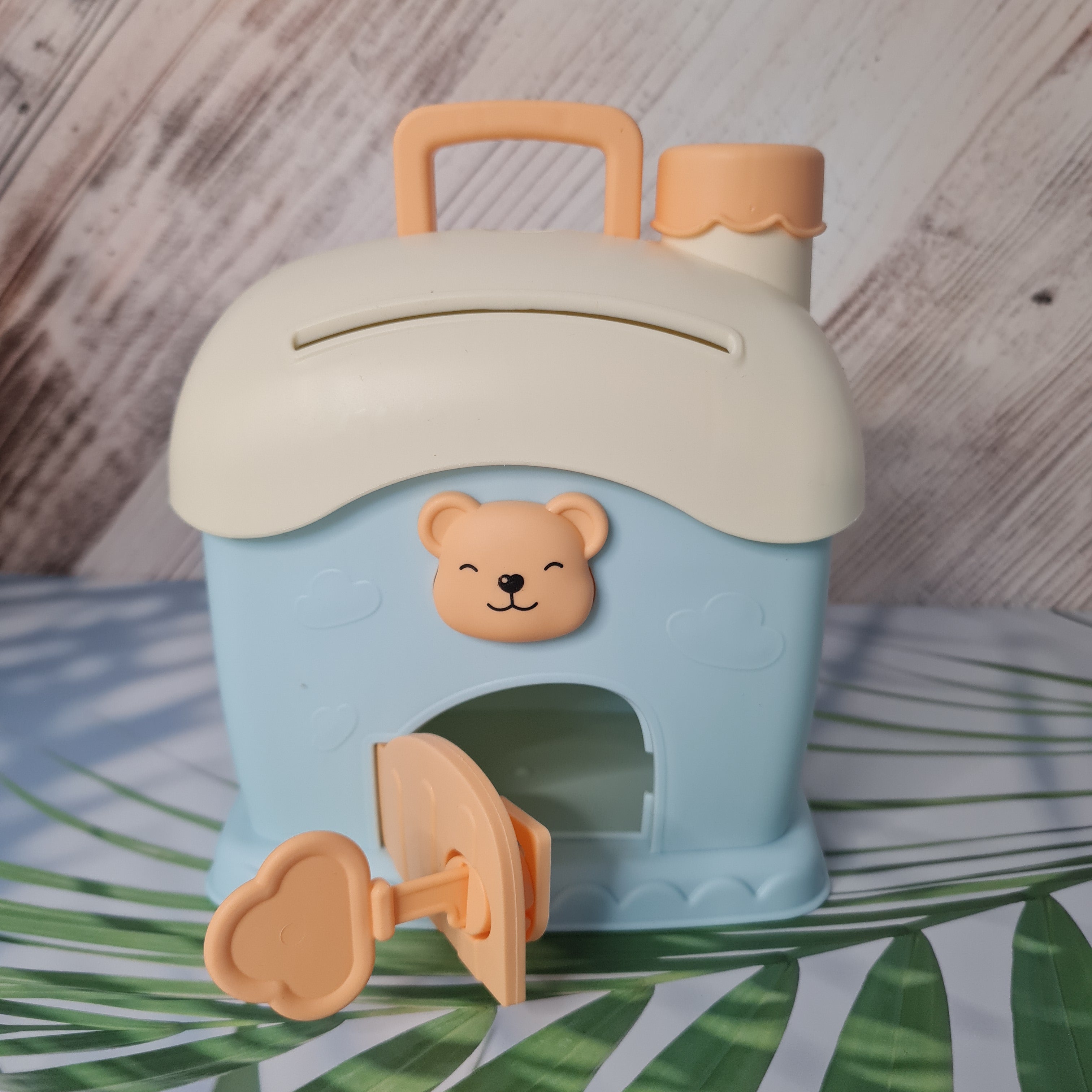 Children's cup with bear design on a wooden surface